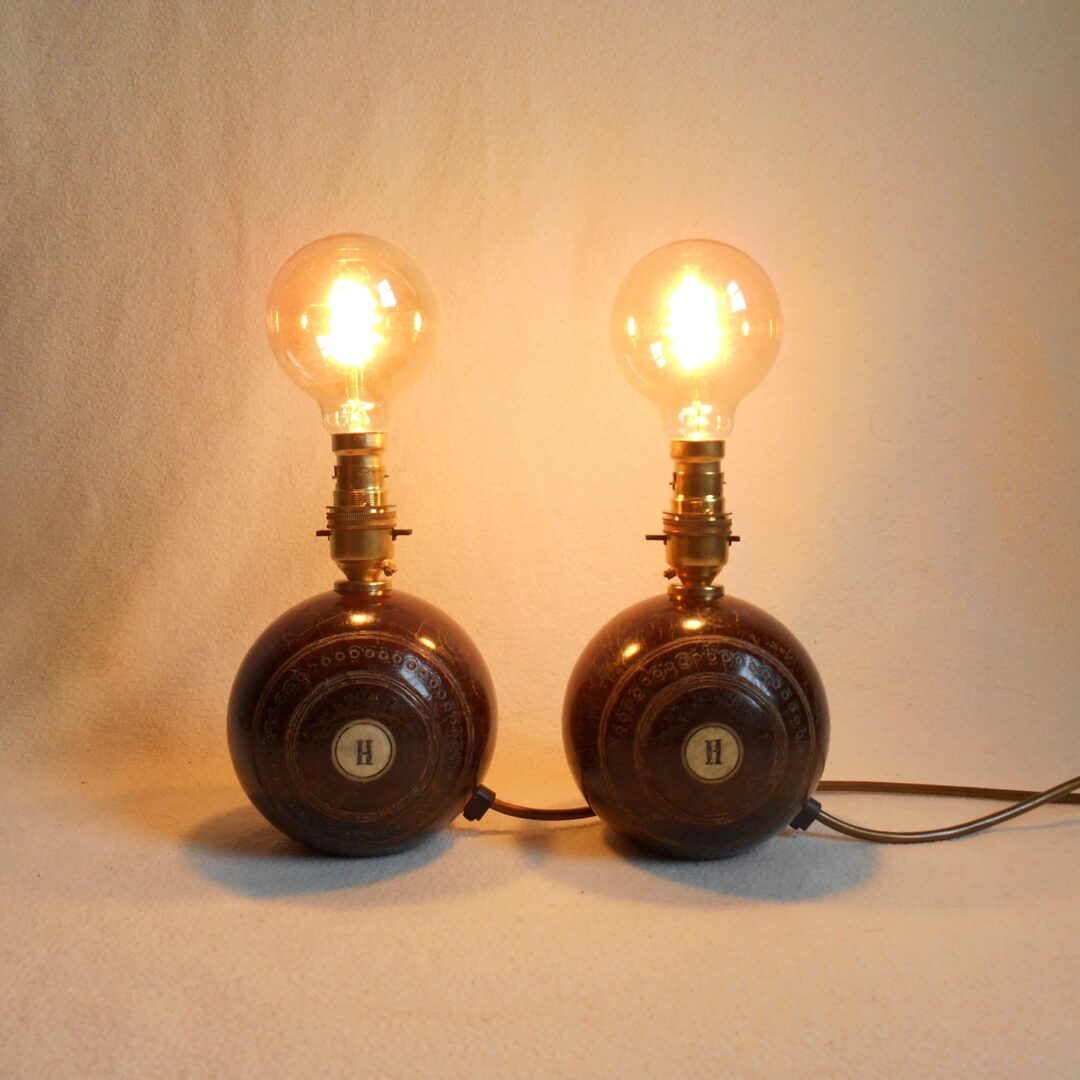 A pair of vintage wooden bowling ball lamps by Fiona Bradshaw Designs