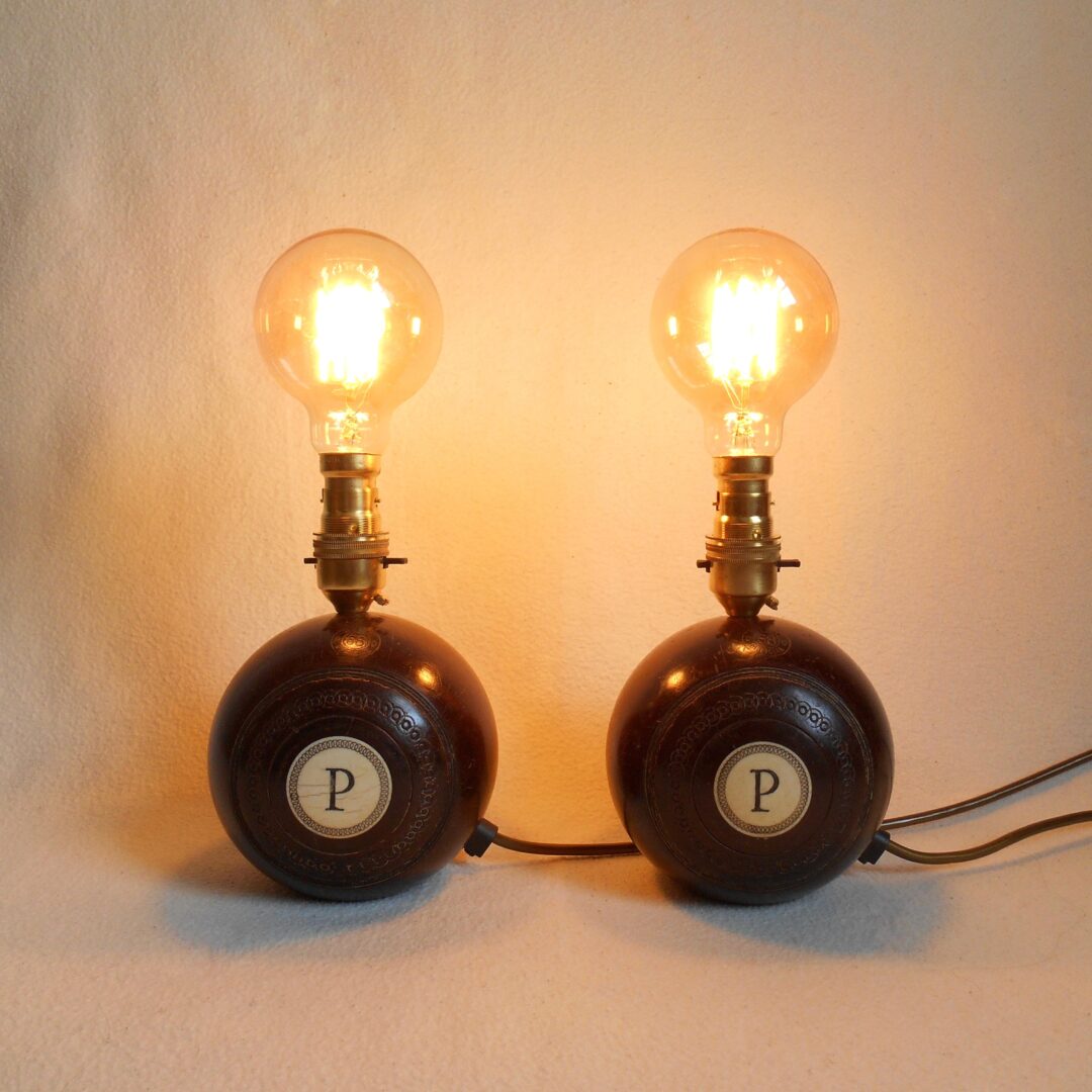 A pair of vintage wooden bowling ball lamps by Fiona Bradshaw Designs