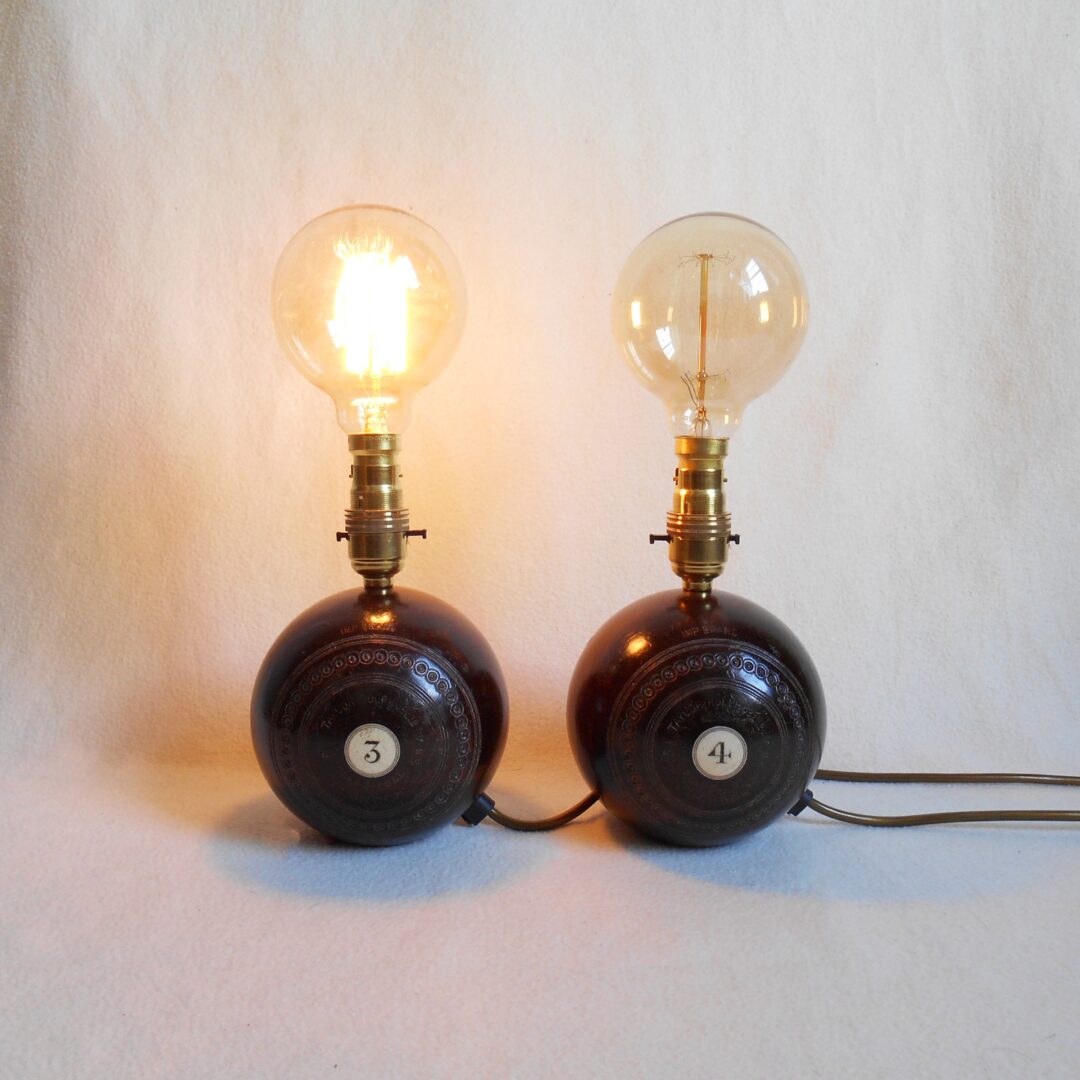 a pair of table lamps made from vintage wooden bowling balls