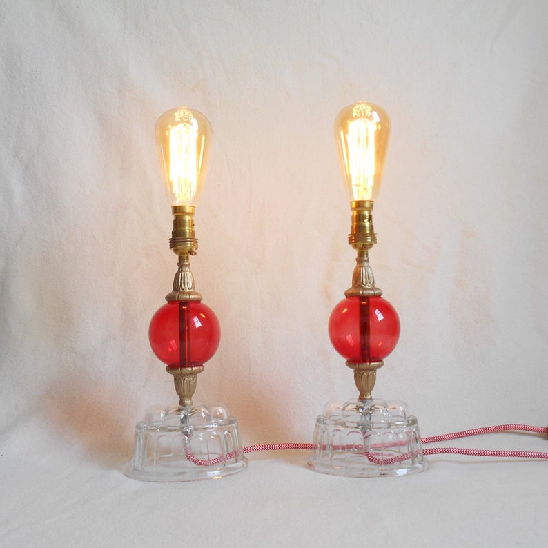 A pair of vintage jelly mould and red glass table lamps