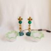 A pair of Art Deco style lamps with frilly green glass shades by Fiona Bradshaw Designs