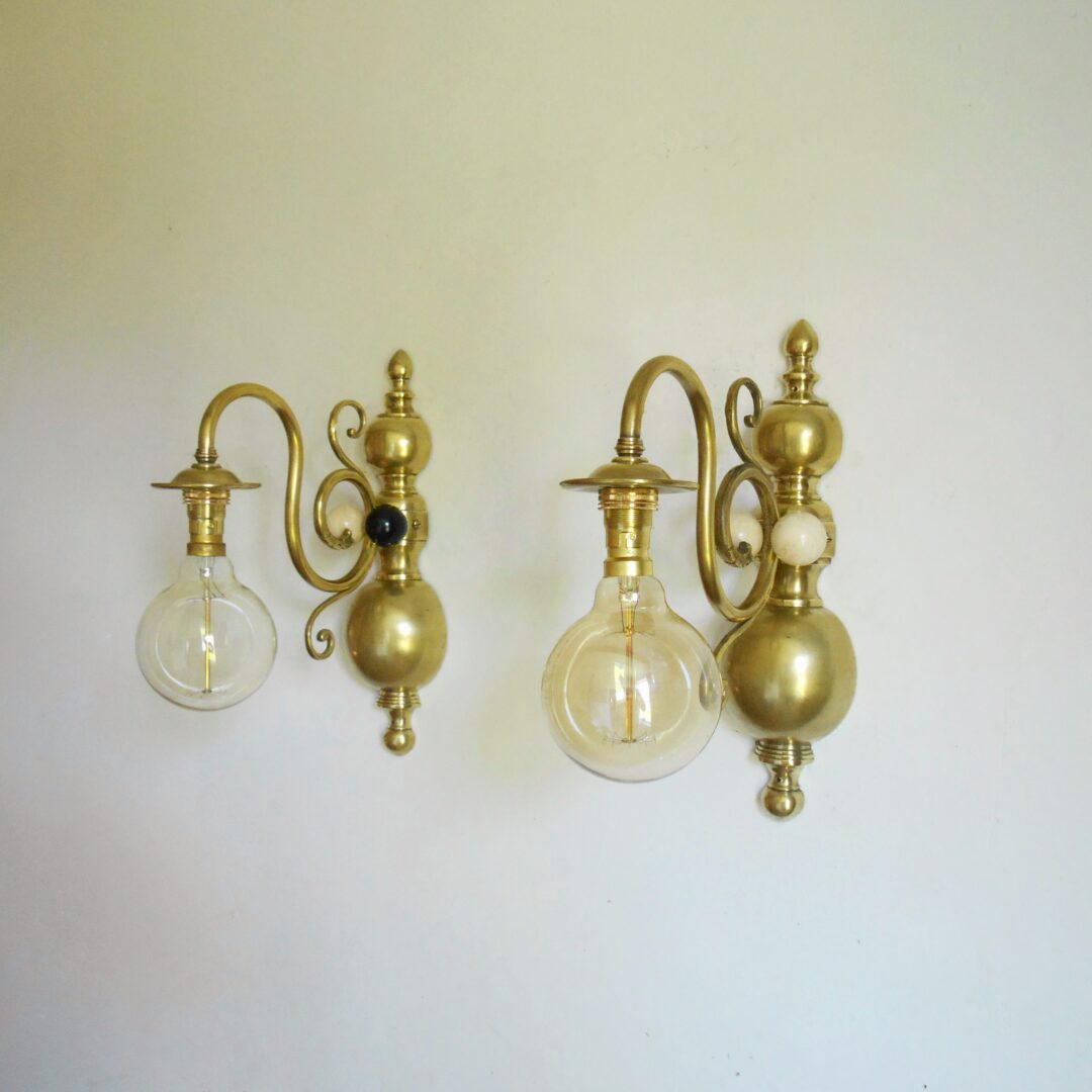 A pair of large solid brass wall lamps with unique features by Fiona Bradshaw Designs