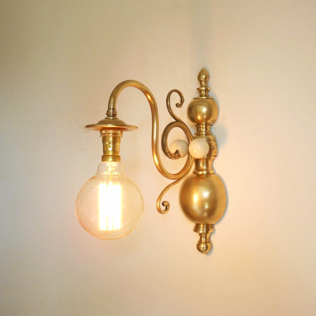A pair of large solid brass wall lamps with unique features by Fiona Bradshaw Designs