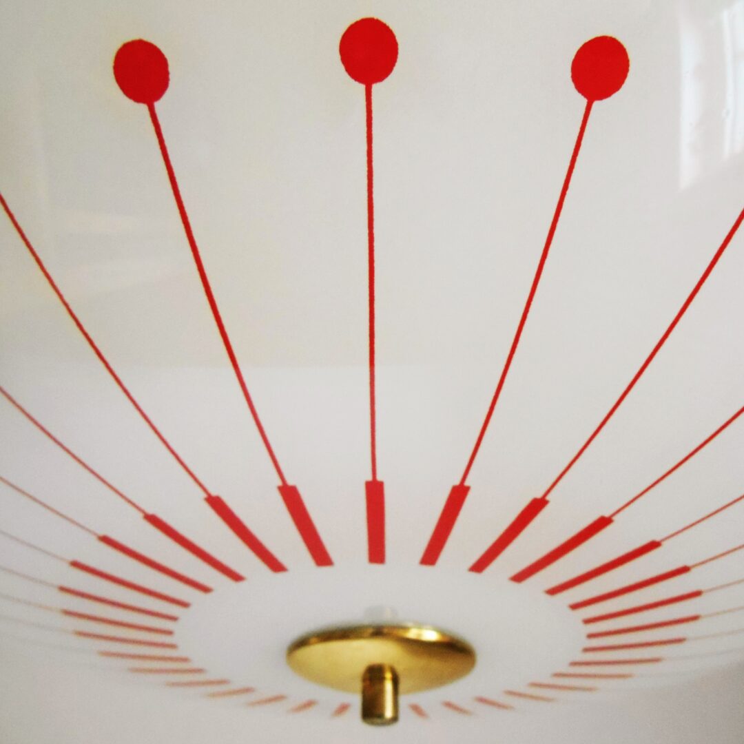 Retro glass pendant lamp with a red and white geometric pattern by Fiona Bradshaw Designs