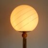 A vintage octagonal oak floor lamp with a glass domed shade by Fiona Bradshaw Designs