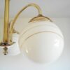 Art Deco style brass chandelier with three glass globe shades by Fiona Bradshaw Designs