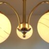 Art Deco style brass chandelier with three glass globe shades by Fiona Bradshaw Designs
