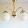 Art Deco style brass chandelier with three glass globe shades by Fiona Bradshaw Designs