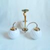 Art Deco style brass chandelier with three glass globe shades by Fiona Bradshaw Designs
