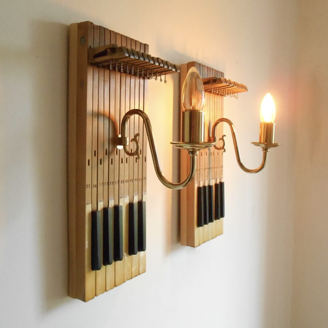 A pair of repurposed wall lamps with antique piano keys by Fiona Bradshaw Designs
