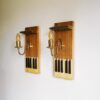 A pair of repurposed wall lamps with antique piano keys by Fiona Bradshaw Designs