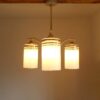 An Art Deco style unique chandelier with three cylindrical shades by Fiona Bradshaw Designs