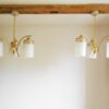 An Art Deco style unique chandelier with three cylindrical shades by Fiona Bradshaw Designs