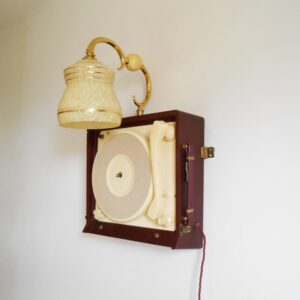 A vintage record player repurposed into a unique wall lamp by Fiona Bradshaw Designs