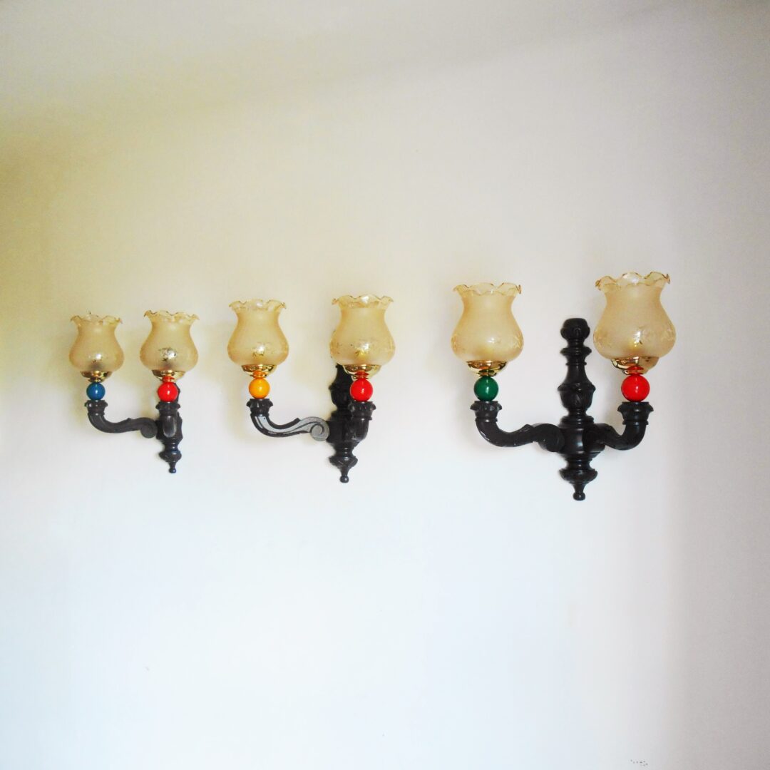 A trio of colourful retro wooden wall lamps by Fiona Bradshaw Designs