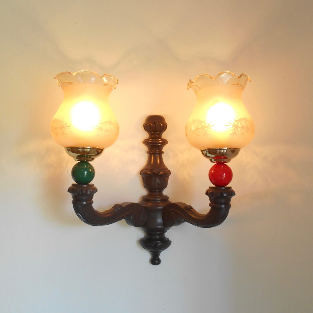 A trio of colourful retro wooden wall lamps by Fiona Bradshaw Designs
