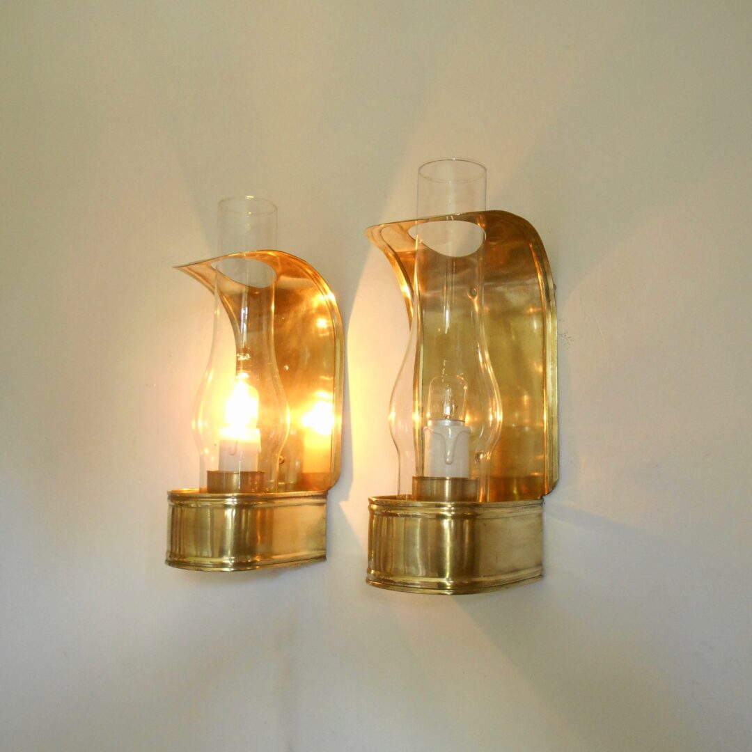 A pair of curved brass vintage wall lamps by Fiona Bradshaw Designs