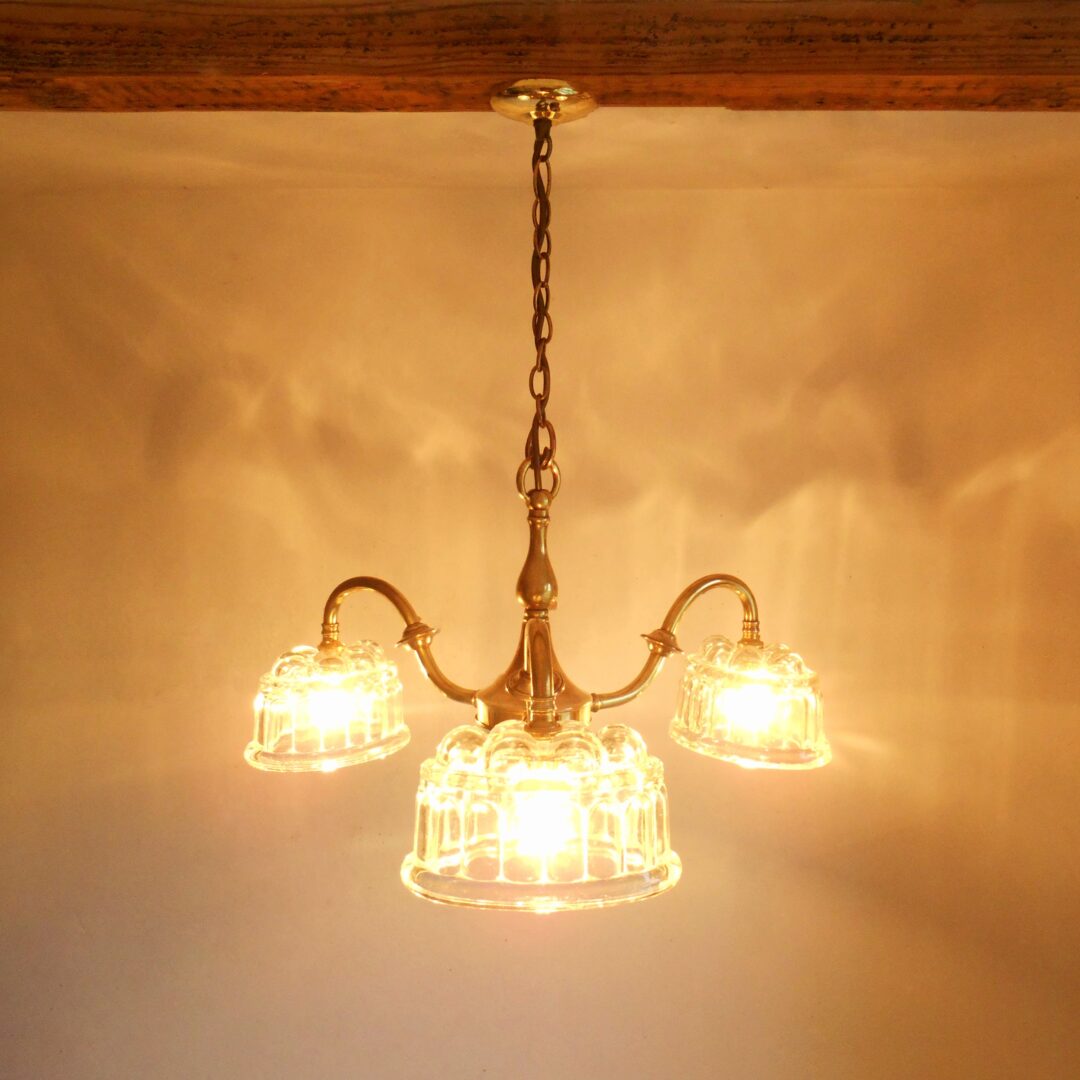 Brass chandelier with jelly mould shades by Fiona Bradshaw Designs