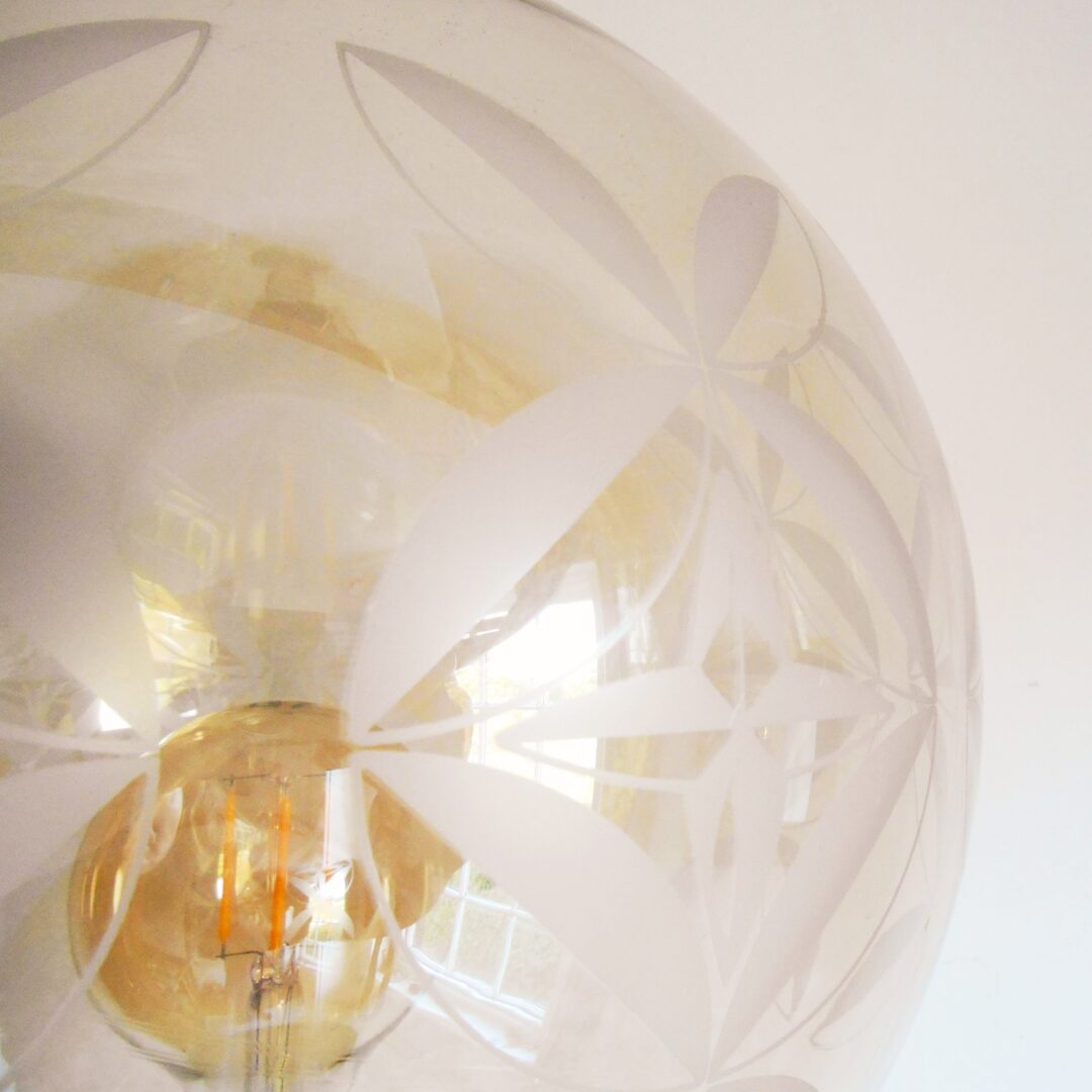 A bespoke gold and navy floor lamp with a vintage glass globe shade by Fiona Bradshaw Designs