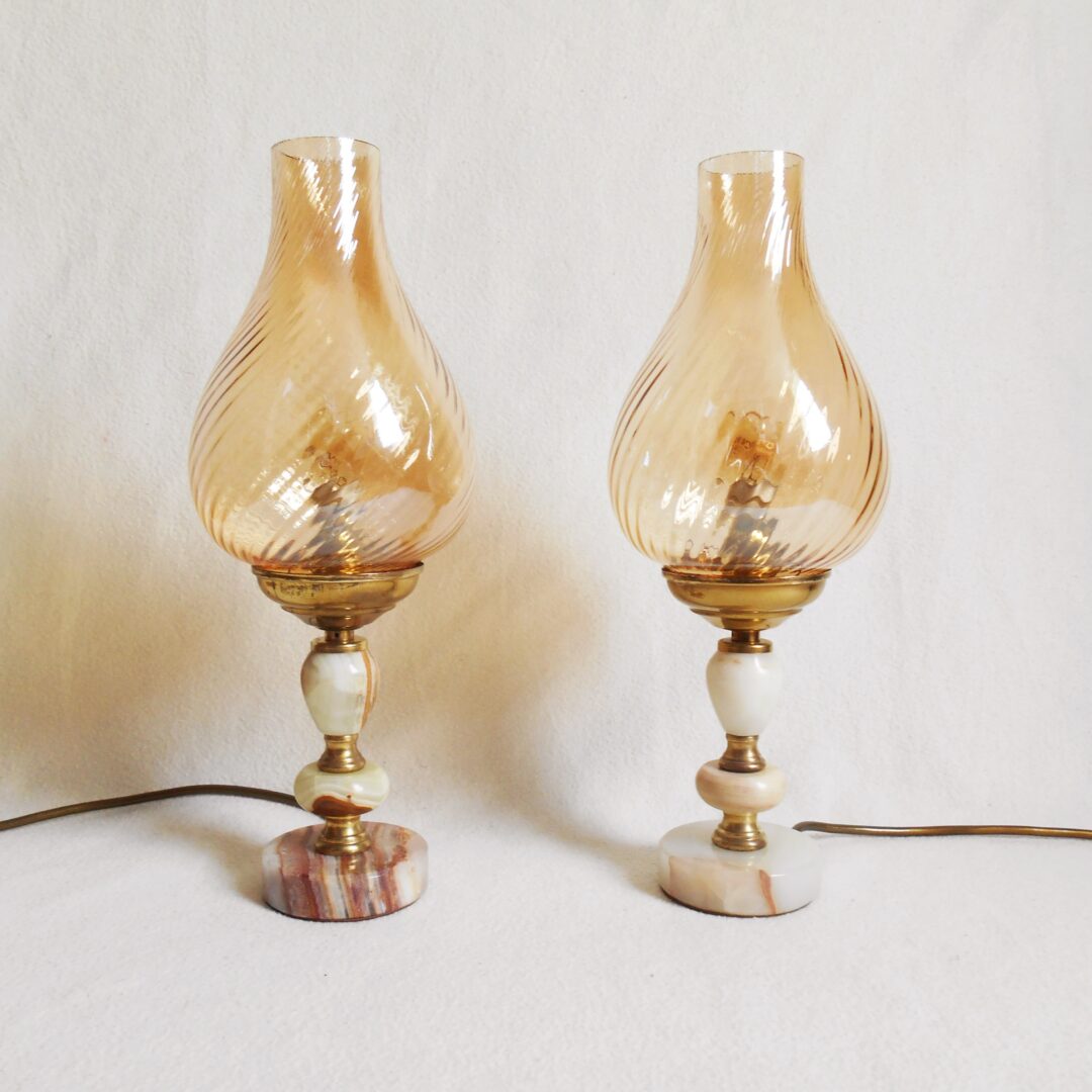 A pair of brass and onyx bedside lamps by Fiona Bradshaw Designs