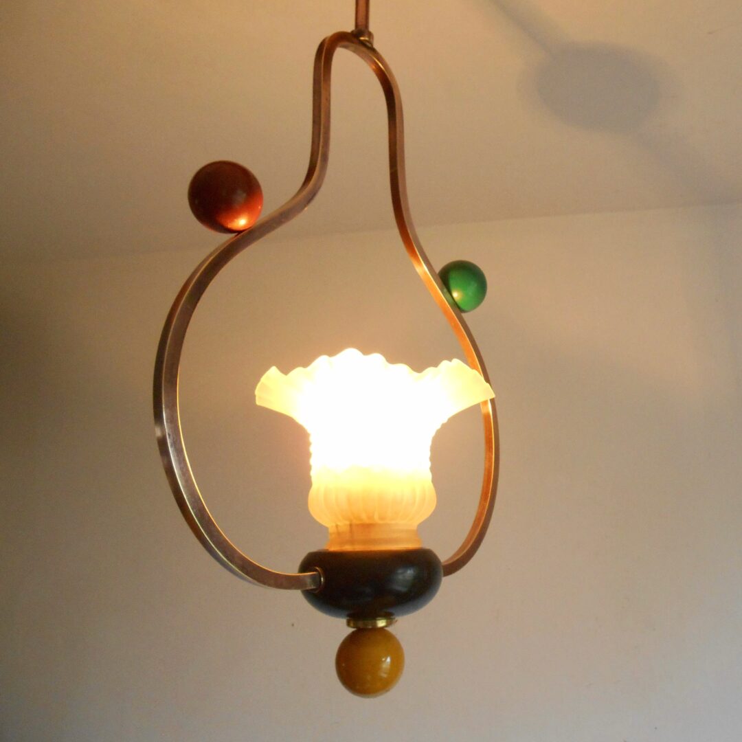 A pair of unique copper pendant lamps by Fiona Bradshaw Designs