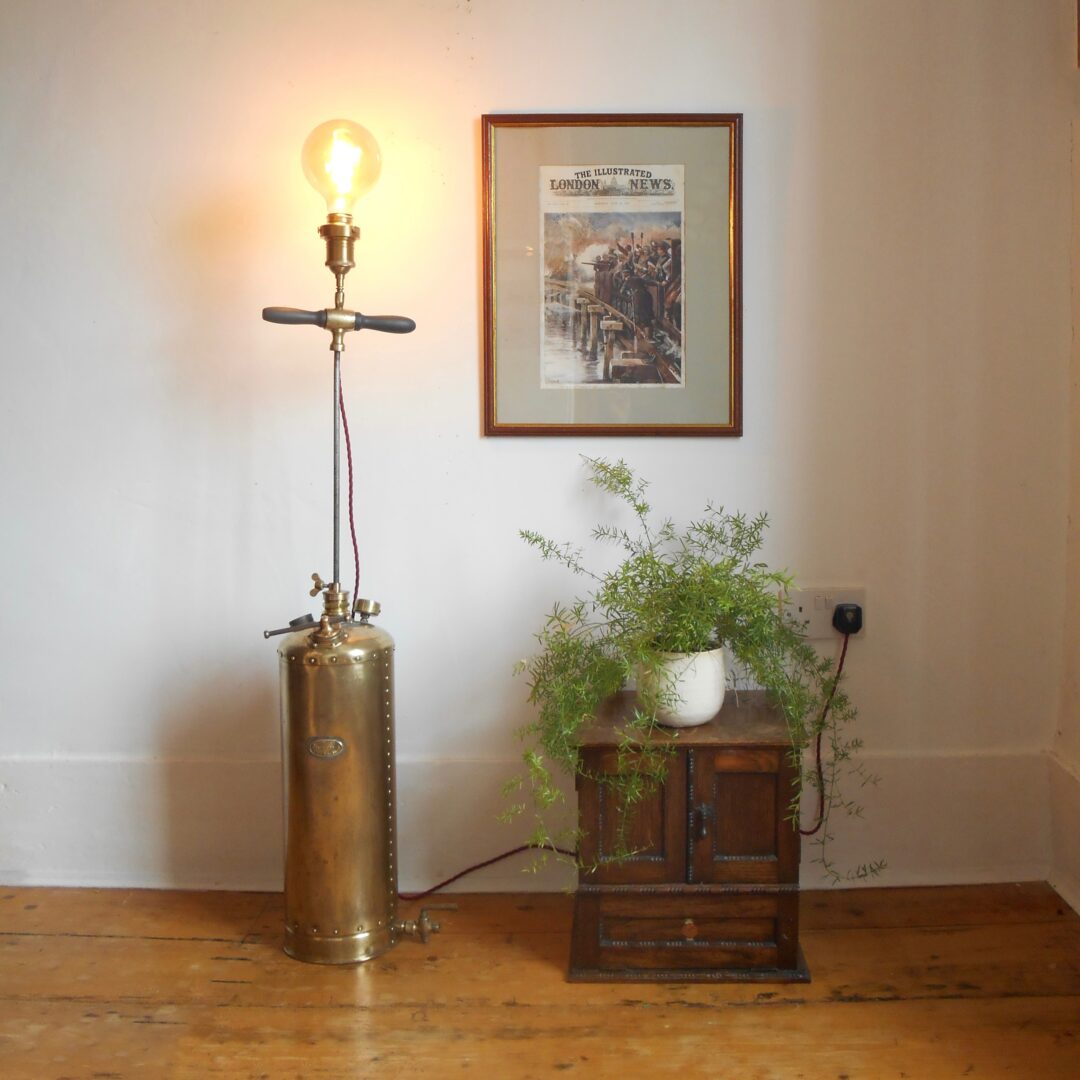 A brass antique garden sprayer floor lamp by Fiona Bradshaw Designs