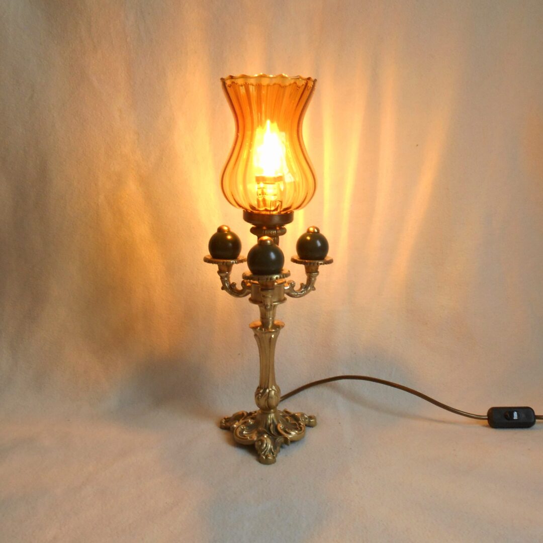A bespoke brass table lamp with an amber glass shade by Fiona Bradshaw Designs.