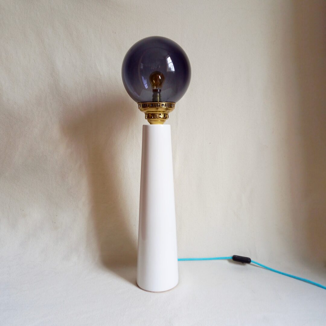 A tall ceramic table lamp with a gorgeous deep purple globe shade by Fiona Bradshaw Designs