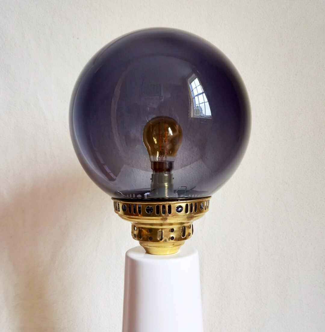 A tall ceramic table lamp with a gorgeous deep purple globe shade by Fiona Bradshaw Designs