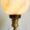 A beautiful Art Deco brass table lamp with a marbled glass shade by Fiona Bradshaw Designs