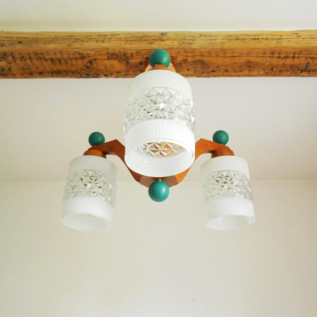 A mid century modern teak chandelier with unique retro features by Fiona Bradshaw Designs