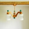A mid century modern teak chandelier with unique retro features by Fiona Bradshaw Designs