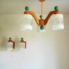 A mid century modern teak chandelier with unique retro features by Fiona Bradshaw Designs