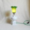 A ceramic white table lamp with a green glass shade by Fiona Bradshaw Designs
