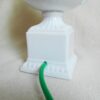 A ceramic white table lamp with a green glass shade by Fiona Bradshaw Designs
