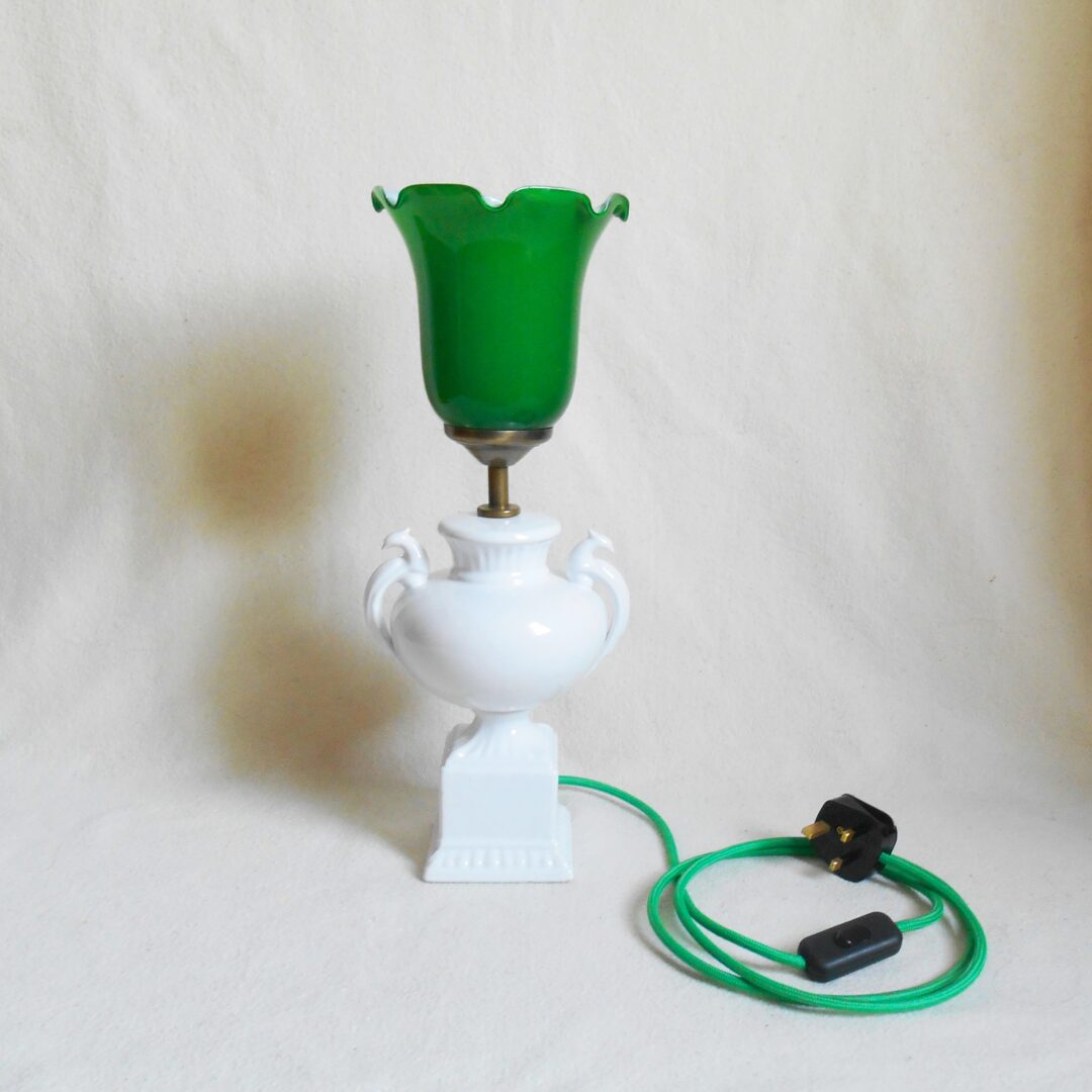 A ceramic white table lamp with a green glass shade by Fiona Bradshaw Designs