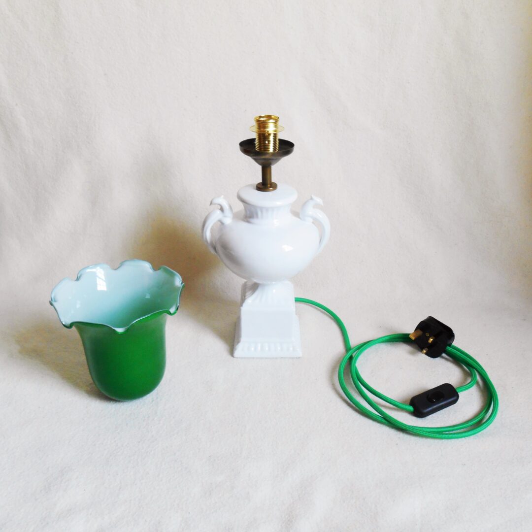 A ceramic white table lamp with a green glass shade by Fiona Bradshaw Designs