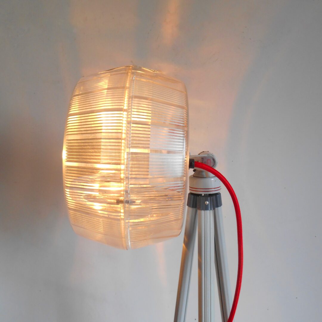 A unique tripod floor lamp with an adjustable holophane shade by Fiona Bradshaw Designs