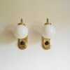 A pair of Art Deco style wall lamps with glass globe shades by Fiona Bradshaw Designs