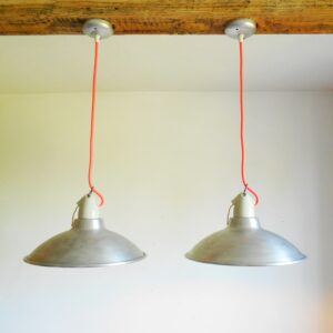 A pair of industrial pendant lamps by Fiona Bradshaw Designs