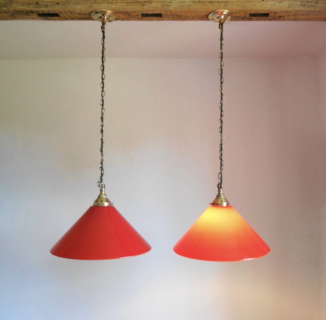 A pair of red pendant lamps by Fiona Bradshaw Designs