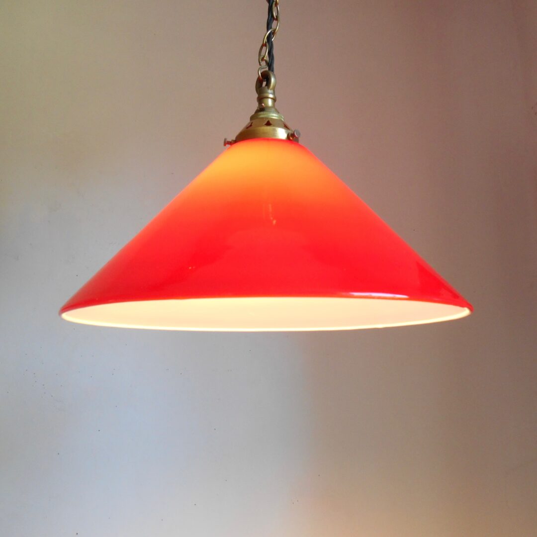 A pair of red pendant lamps by Fiona Bradshaw Designs