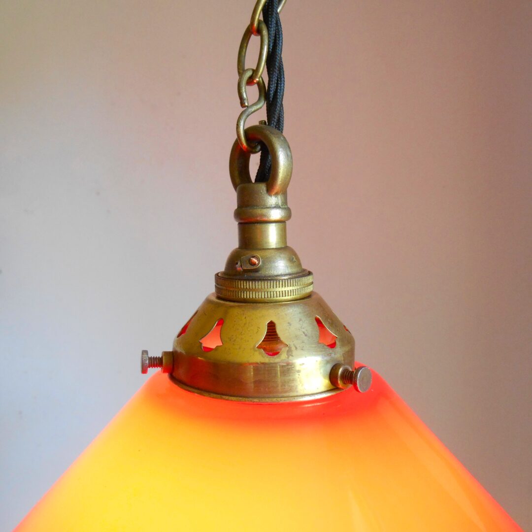 A pair of red pendant lamps by Fiona Bradshaw Designs