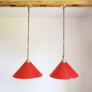 A pair of red pendant lamps by Fiona Bradshaw Designs